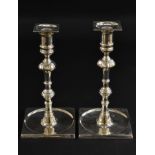 A pair of George II paktong table candlesticks, of seamed construction, detachable nozzles,