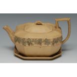 A Wedgwood Cane ware canted square teapot, cover and stand, applied with fruiting vine, 20cm wide,
