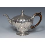 A 19th century Portuguese silver melon shaped teapot, chased and engraved with flowers,
