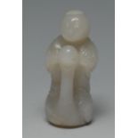 A Chinese white jade, carving of a boy, standing on a swan,