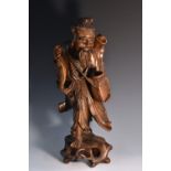 A Chinese hardwood figure, of a fisherman, he stands holding creel and catch, 45cm high, c.