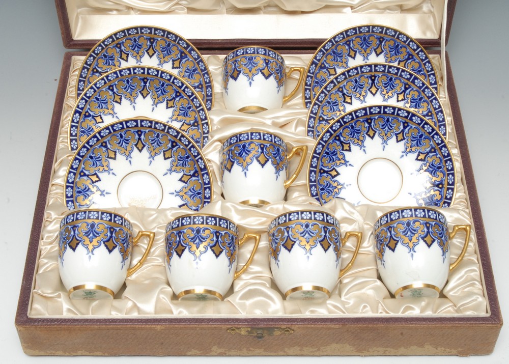 A set of six Coalport demi-tasse cups and saucers,