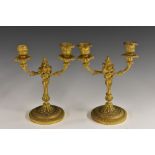 A pair of 19th century Rococo Revival gilt-metal candelabra, cast throughout with acanthus,