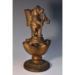 A 19th century cast iron novelty pipe stand/vesta, as a bear, he stands,