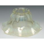 A late 19th century vaseline glass wavy edged light shade, approx 31cm diam, c.