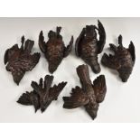 A set of six early 19th century oak trompe-l'œil carvings,