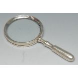 A George V silver magnifying glass, of typical form, 18cm long,