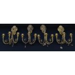 A set of four 19th century giltwood and gesso three-light wall sconces, campana sconces,