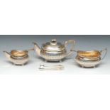 A George III silver three piece half-fluted boat shaped tea service, comprising teapot,