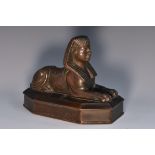 An early 19th century brown patinated bronze desk weight, cast as a sphinx, lozenge shaped base, 14.