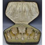 An Art Nouveau silver six piece dressing table set, the backs embossed with lilies,