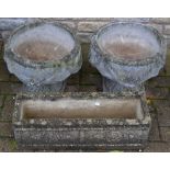 Two reconstituted stone urnular planters, decorated with swags; another,