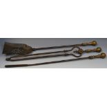 A set of three George III steel and brass fire irons, comprising shovel, poker and tongs,