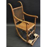 A 19th century beech invalid chair, bergere back and seat, c.