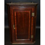 A George III oak splay front corner cabinet c.