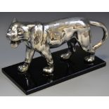 A chrome model, of a lion, standing, black plinth,