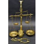 A set of brass counter balance scales, bulls head capital, suspended pan dishes,
