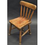 A 19th century elm child's kitchen chair, spindle back, H stretcher, c.