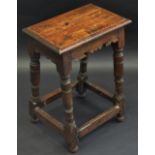 An 18th century oak joint stool, rectangular top, turned legs, rectangular stretchers, 59cm high,