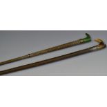 A lady's riding crop, horn handle, as a boot; another,