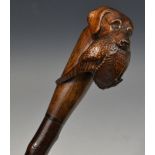 A black thorn walking cane, the terminal well carved with labrador and peasant,