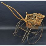 A 19th century child's wicker Rickshaw/cart, iron spoked wheels,