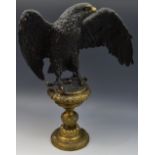 After Archibald Thorburn, a brown patinated sculpture, of an eagle, with wings outstretched,