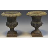 A pair of small cast iron campana shaped urns, 18.