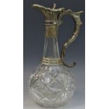 A Victorian glass and plated claret jug, hinged cover, the mask and scroll handle,