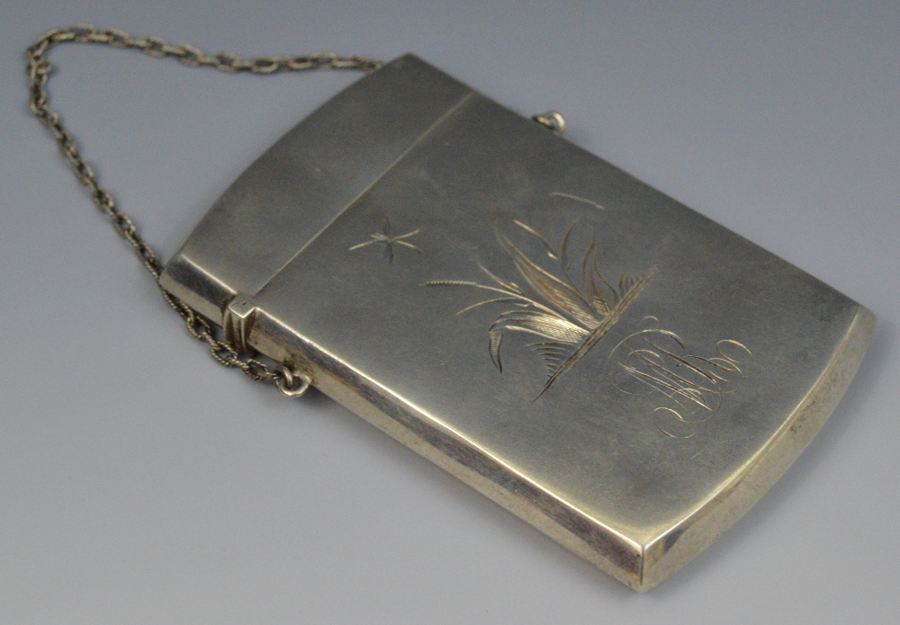 A silver rectangular visiting card case, possibly American, engraved with foliage,