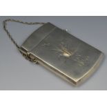 A silver rectangular visiting card case, possibly American, engraved with foliage,