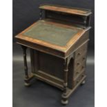 An oak Davenport, three quarter brass galleried superstructure, four faux drawer cupboard to side,