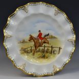 A Royal Crown Derby wavy edge plate, decorated with huntsman taking a fence,