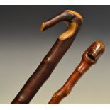 A lady's pyrocantha walking cane, primitive carved face to handle; another,