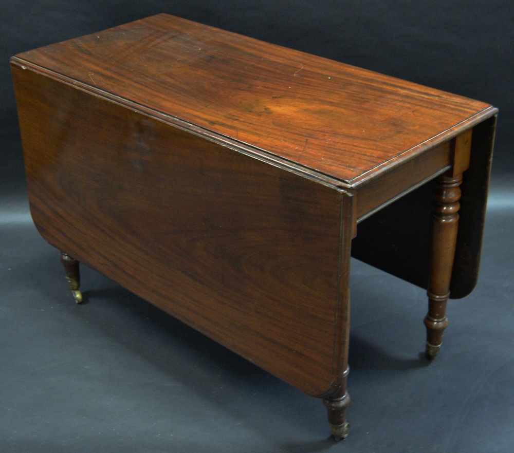 An early Victorian mahogany rounded rectangular drop leaf table, moulded top, turned legs,