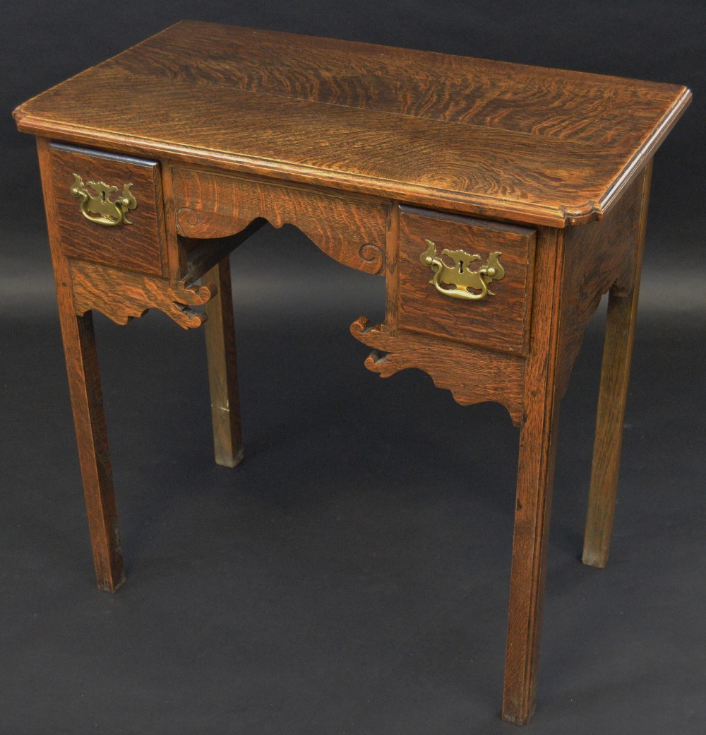 A George III oak lowboy, shaped moulded rectangular top, shaped apron, two deep short drawers,