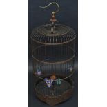 A Chinese domed bird cage, with cloisonne vasular feeders, the base carved with figures,