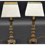 A pair of French softwood table lights, in the 17th century style, knopped columns, triform bases,