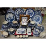 A Staffordshire blue and white transfer printed Willow pattern dinner and tea service;