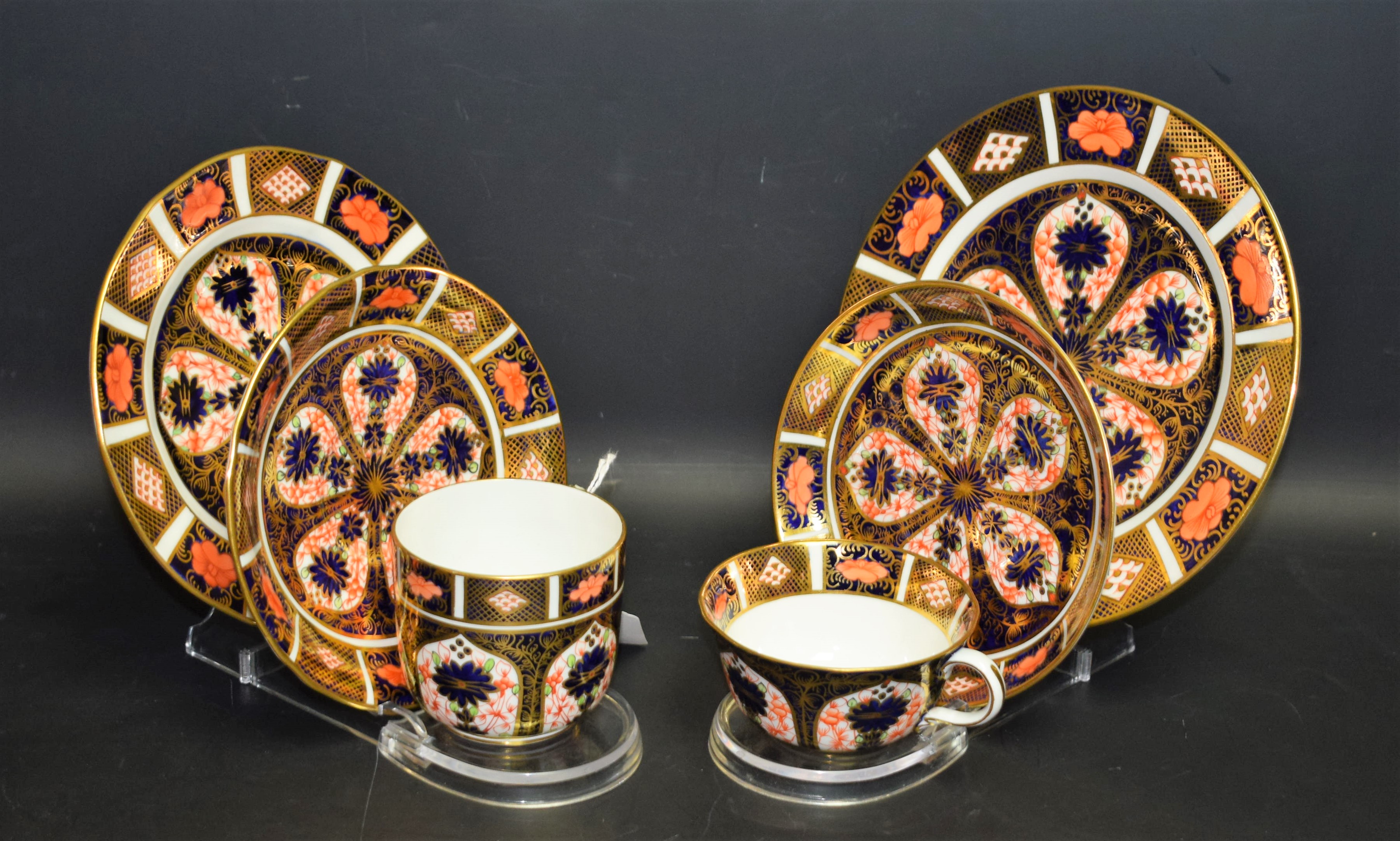 A Royal Crown Derby 1128 Imari pattern trio, teacup, saucer and side plate; another,