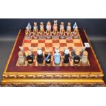 A novelty chess set, pieces cast as dogs and cats, ornate gilt board and stand,