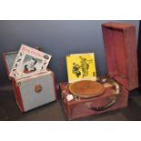 A Meltrope III gramophone, burgundy case, needle tins, records,