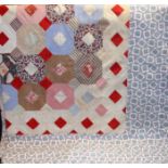 A patchwork bedcover, geometric design in plain and printed cotton, floral print border,