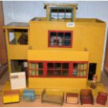 A 1930's two story dolls house, flat roof, hinged door,