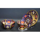 A Caverswall Romany pattern teacup trio;