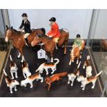 A Beswick hunting group, comprising a gentleman and a lady on horseback, pony with rider,