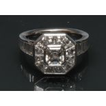An Art Deco style diamond cluster ring, central square emerald cut diamond approx 1.