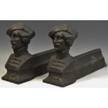 A pair of black fire andirons, the terminals cast with busts, of gentlemen,