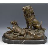 After Gardet, 20th century, a brown patinated sculpture, Lion and Lioness, oval belge noir base,