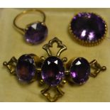 A 9ct gold purple stone solitaire ring, claw set, pierced sides, gross weight 4.